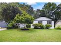 Nice home with a well-manicured lawn and mature trees at 464 Rockborough Ter, Stone Mountain, GA 30083