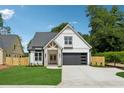 Charming two-story home features a stone-accented entrance, a garage with horizontal windows and a well-manicured lawn at 1780 Aircraft Se Dr, Marietta, GA 30060
