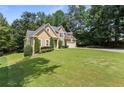Traditional home with a stone facade and large front yard at 2709 Gentry Dr, Douglasville, GA 30135