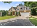 Traditional home boasts a stone facade, well-kept lawn, and two-car garage at 2709 Gentry Dr, Douglasville, GA 30135