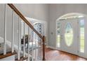 Elegant foyer features hardwood floors, white trim, and a decorative glass front door at 2709 Gentry Dr, Douglasville, GA 30135