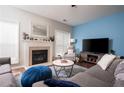 Bright living room featuring a fireplace, large windows, and stylish furnishings at 971 Brownstone Ln # 18, Marietta, GA 30008