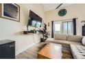 Contemporary living room with wood flooring, a mounted television, neutral couch and natural light from an outdoor view at 799 Hammond Dr # 427, Atlanta, GA 30328