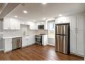 Modern kitchen featuring white cabinets, stainless steel appliances, and hardwood floors at 1441 Monteel Nw Dr, Atlanta, GA 30318