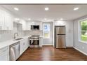 Bright kitchen with white cabinets, stainless steel appliances, and hardwood floors at 1441 Monteel Nw Dr, Atlanta, GA 30318