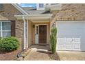 Inviting front entrance with a dark wood door, sidelight, and brick facade at 137 Hidden Lake Cir, Canton, GA 30114