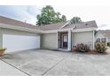 Side exterior showcasing a two-car garage, covered entryway, and well-maintained landscaping at 167 Camry Ln, Grayson, GA 30017