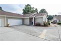 External view of the two-car garage and covered entryway with vibrant bushes surrounding the property at 167 Camry Ln, Grayson, GA 30017