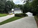 Spacious garage with ample parking and storage, complemented by lush landscaping at 3970 Governor'S Circle, Loganville, GA 30052