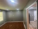 Bright living room featuring hardwood floors, recessed lighting, and a view into the kitchen at 273 Fennel Way, Atlanta, GA 30331