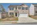 Charming two-story brick home with a two-car garage and well-maintained front lawn at 1936 Waycross Ln, Dacula, GA 30019
