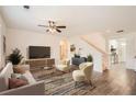 Bright living room features stylish furniture, a ceiling fan, and hardwood floors at 1936 Waycross Ln, Dacula, GA 30019