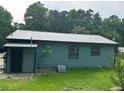 Charming home with blue siding, metal roof, and a well-maintained lawn at 3730 Clovis Court Northwest Nw Ct, Atlanta, GA 30331
