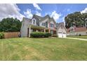 Beautiful two-story home with a large front yard, attached garage, and a charming front porch at 524 Birchwood Dr, Temple, GA 30179
