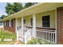 Close up of porch area, detailed with white railings and stairs leading to the entrance at 999 Chestnut Oak Ct, Lawrenceville, GA 30046