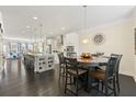 Spacious open-plan kitchen and dining area with hardwood floors and modern pendant lighting at 1292 Park Bench Pl, Mableton, GA 30126