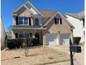 Charming two-story brick home with a well-manicured lawn and attached two-car garage at 1295 Leisure Lake Dr, Lawrenceville, GA 30044