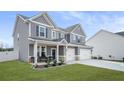 Attractive gray two-story house with manicured lawn, covered porch, and a two-car garage at 1049 Bodega Loop, Locust Grove, GA 30248