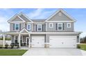 Inviting gray two-story home with well-maintained lawn and a convenient two-car garage at 1049 Bodega Loop, Locust Grove, GA 30248