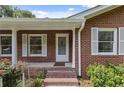 Inviting front porch with brick steps, white columns, and well-manicured landscaping at 1051 Rock Springs Rd, Lawrenceville, GA 30043