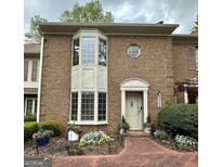 Brick townhouse exterior with bay window and landscaping at 3469 Ashwood Ln, Atlanta, GA 30341