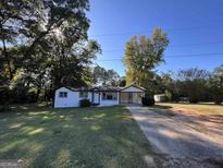 Ranch style home with a carport and a large front yard at 171 Plantation Dr, Fayetteville, GA 30215