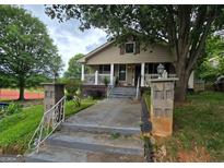 Inviting home showcasing a quaint porch, columns, and easy access concrete pathway at 212 Little St, Atlanta, GA 30315