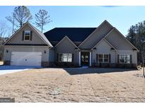 Gray two-story house with a three-car garage and large yard at 329 Rays Ct # 12, Grayson, GA 30017