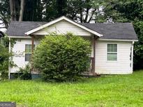Modest one story home with horizontal siding and a covered front porch at 3494 Thompson Dr, Atlanta, GA 30331