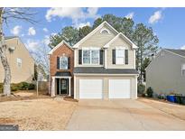 Two-story house with brick and siding exterior, two-car garage, and landscaping at 4248 Brighton Nw Way, Kennesaw, GA 30144