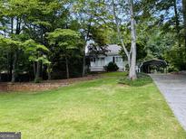 Charming single-story home with a lovely front yard and a covered carport at 2606 Ramblewood Ct, Acworth, GA 30102