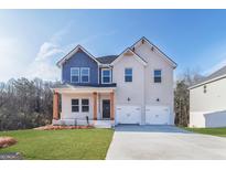 Two-story home boasting a brick facade, a two-car garage, and a well-manicured lawn at 271 Orwell Dr # 49, Social Circle, GA 30025