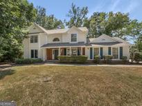 Charming two-story home boasts curb appeal with its well-maintained lawn and inviting facade at 9997 Point View Dr, Jonesboro, GA 30238