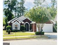 Charming brick home featuring well-manicured landscaping and a two-car garage at 121 Pinnacle Ln, Mcdonough, GA 30253