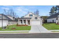 Brick house with a two-car garage and landscaped lawn at 568 Parnassus Rd, Locust Grove, GA 30248