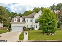 Charming two-story home with a well-manicured lawn and a two car garage at 2560 Almont Way, Roswell, GA 30076
