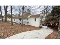 White house with wraparound porch and large backyard at 164 Glenloch Pkwy, Stockbridge, GA 30281