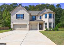 Beautiful two-story home featuring a three-car garage, a well-maintained lawn, and meticulous landscaping at 161 Jodi Pl, Locust Grove, GA 30248