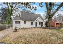 Charming, cottage-style home featuring a newly painted exterior, landscaped yard, and mature shade trees at 2013 Marco Dr, Decatur, GA 30032