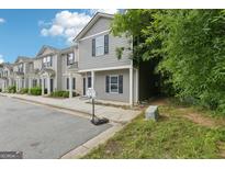 Charming two-story townhome with gray siding and black shutters near a basketball hoop at 4001 Avalon Sw Rd, Atlanta, GA 30331