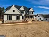 Two-story house with gray siding, stone accents, and a covered porch at 140 Dockside Dr # 381, Fayetteville, GA 30215