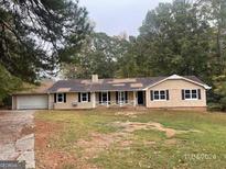 Charming single-story home with a spacious front yard and attached garage at 2177 E Chester Cir, Conyers, GA 30013