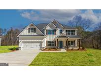 Stunning two-story home featuring white siding, stone accents, and a well-manicured lawn at 515 Bohannon Rd # 13, Grantville, GA 30220