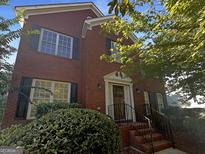 Charming brick home featuring black shutters, manicured landscaping and a welcoming front entrance at 200 Eagle Glen Ct, Woodstock, GA 30189