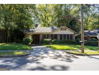 Brick home with screened porch and yard at 1852 Mercer Ave, College Park, GA 30337