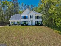 Charming two-story home with classic design, black shutters, and a well-manicured lawn at 22 Agean Way, Whitesburg, GA 30185