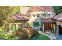 Elegant home exterior boasts a red tile roof, colorful windows and a stone walkway at 1043 Mcconnell Dr, Decatur, GA 30033