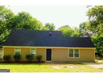Charming single-story home featuring manicured lawn and simple landscaping at 99 Libby Ln, Jonesboro, GA 30238