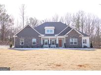 Two-story house with stone accents and a landscaped yard at 152 Wet Wood Dr # 10, Fairburn, GA 30213