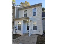 Charming townhouse featuring a covered entryway and a bright, neutral-colored facade with plenty of windows at 6500 Wellington Chase Ct, Lithonia, GA 30058